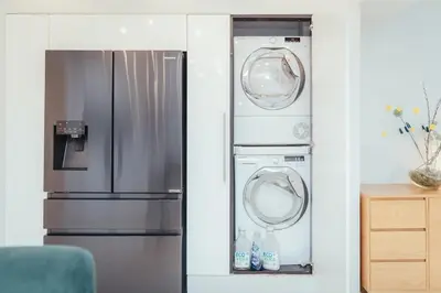 a kitchen with a refrigerator and a washer and dryer at 5 Bed Family Home- Free Parking in Woodham Ferrers Station