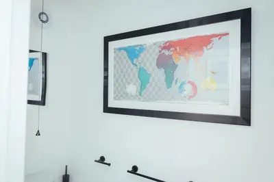 a framed map of the world on a white wall at 5 Bed Family Home- Free Parking in Woodham Ferrers Station