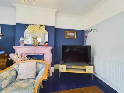 a living room with a couch and a tv at 2 Bed Apartment- Leigh Broadway in Southend-on-Sea