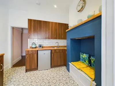 a kitchen with a sink and a blue wall at 2 Bed Apartment- Leigh Broadway in Southend-on-Sea