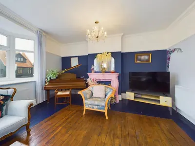 a living room with a television and a piano at 2 Bed Apartment- Leigh Broadway in Southend-on-Sea