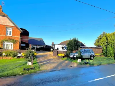 a house with a car parked on the side of a street at Country View place in Weeley