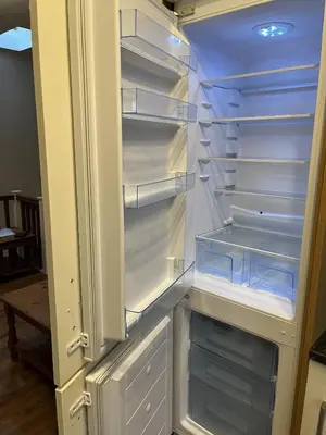 a refrigerator with its door open with its empty shelves at Haven Hideaway in Harwich