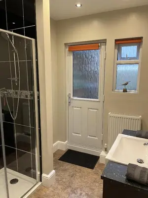 a bathroom with a shower and a sink and a tub at Haven Hideaway in Harwich