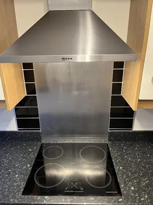 a stove top in a kitchen with a hood at Haven Hideaway in Harwich