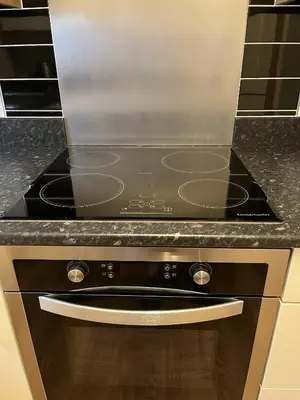 a black stove top oven in a kitchen at Haven Hideaway in Harwich