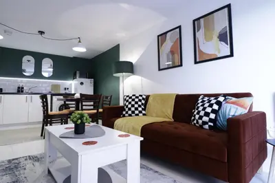 a living room with a couch and a table at Comfy Town Centre Apartment Free Parking WiFi in Colchester