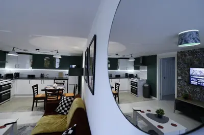 a view of a living room and kitchen from a mirror at Comfy Town Centre Apartment Free Parking WiFi in Colchester