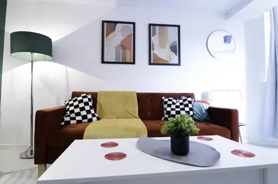 a living room with a couch and a table at Comfy Town Centre Apartment Free Parking WiFi in Colchester