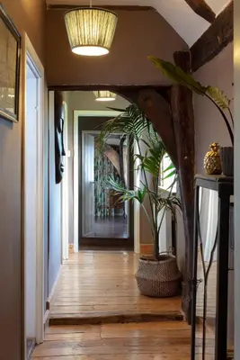 a hallway with a potted plant in the middle of it at Farmhouse in Suffolk with wild swimming & hot tub in Saint Margaret