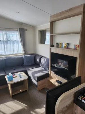 a living room with a couch and a fireplace at F86 Steeple Bay in Steeple