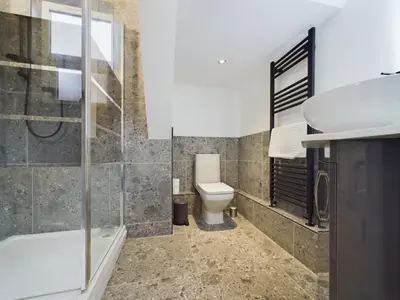 a bathroom with a toilet and a shower and a sink at Westcliff apartment with free parking in Southend-on-Sea