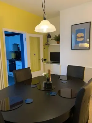 a dining room with a table and chairs and a kitchen at 3 Bed Family House Free Parking in Southend-on-Sea