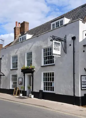a white building with a sign for a street house at Earsham Street House in Bungay