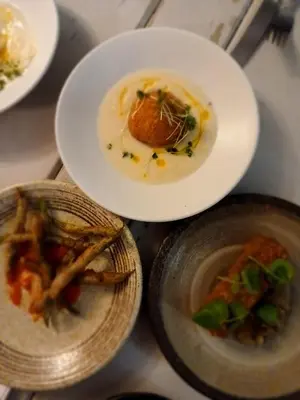 a table topped with plates of food on top at Earsham Street House in Bungay