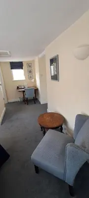 a living room with a couch and a table at Earsham Street House in Bungay