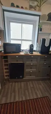 a desk with a window and a laptop on it at Earsham Street House in Bungay