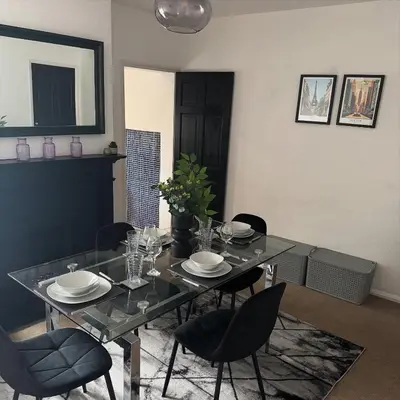 a dining room table with black chairs and a black table and chairsktop at Cosy Home in Chelmsford City, Free WiFi & Free Parking - Mildmay House by Stays Accommodation - Long Stays Welcome in Chelmsford