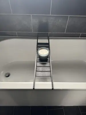 a clock sitting on a ladder in a bath tub at Cosy Home in Chelmsford City, Free WiFi & Free Parking - Mildmay House by Stays Accommodation - Long Stays Welcome in Chelmsford
