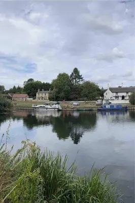 a view of a lake with boats in the water at Outbuilding with river views in Cambridgeshire in Holywell