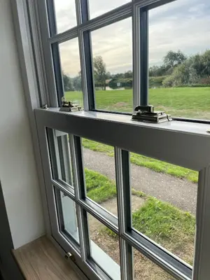 a window with a view of a field at Outbuilding with river views in Cambridgeshire in Holywell