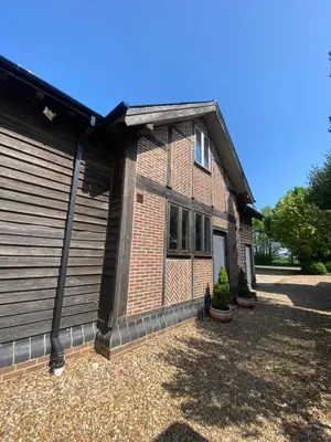 a brick house with a garage at Charming 2-Bedroom Cottage in Cambridgeshire in West Wratting