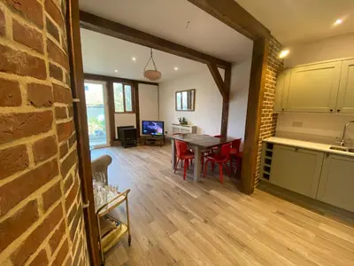 a kitchen and dining room with a table and chairs at Charming 2-Bedroom Cottage in Cambridgeshire in West Wratting
