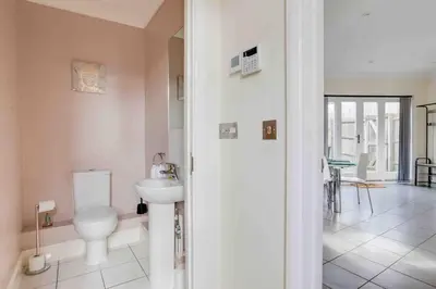 a bathroom with a toilet and a sink at Elizabeth Four Bedroom Townhouse in Bocking Churchstreet