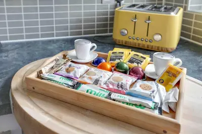 a tray filled with food on a table at Elizabeth Four Bedroom Townhouse in Bocking Churchstreet