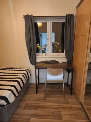 a bedroom with a desk and a window at Happy place in Milton