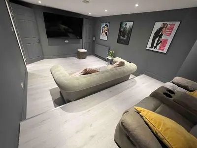 a man laying on a couch in a living room at An Escape to the Country in Rochford