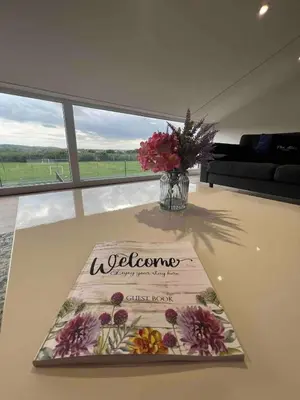 a table with a vase of flowers on top of it at An Escape to the Country in Rochford