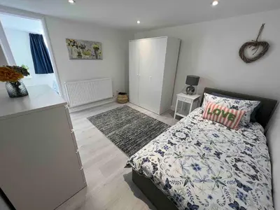 a small bedroom with a bed and a rug at An Escape to the Country in Rochford
