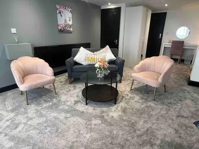 a living room with a couch and two chairs and a table at An Escape to the Country in Rochford