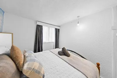 a bedroom with a bed with pillows on it at Charming 3 Bedroom Detached Cottage With Garage in Wormley