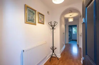 a hallway with a floor lamp in a home at Holly Close in Ipswich