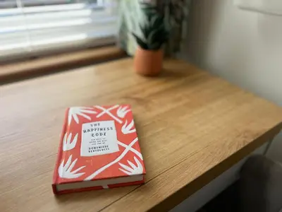 a red box sitting on a wooden table at 2 Bedroom Apartment 11 Minutes From Stansted Airport in Great Dunmow