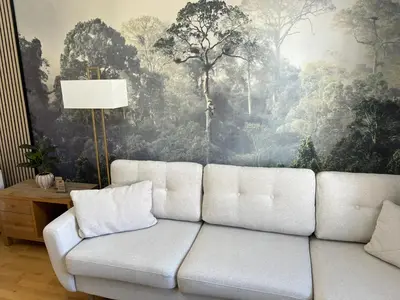 a white couch in a living room with a painting at 2 Bedroom Apartment 11 Minutes From Stansted Airport in Great Dunmow