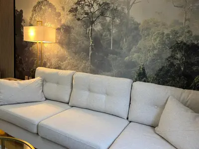 a white couch in a living room with a painting at 2 Bedroom Apartment 11 Minutes From Stansted Airport in Great Dunmow