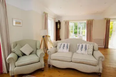 two chairs and a couch in a living room at Beautiful country home and garden in Kirby Cross