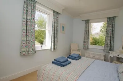 a bedroom with a bed with two blue towels on it at Beautiful country home and garden in Kirby Cross