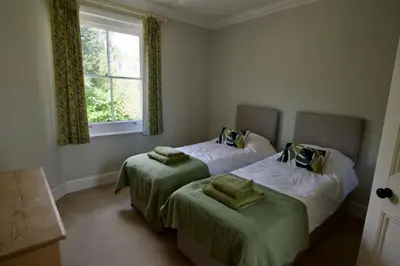 a bedroom with two beds and a window at Beautiful country home and garden in Kirby Cross