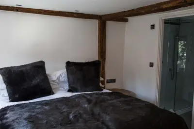 a bedroom with a bed with two black pillows at Idle Waters in Dedham