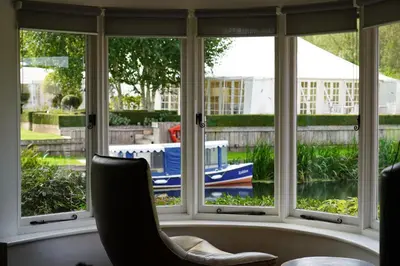 a window with a view of a boat in the water at Idle Waters in Dedham
