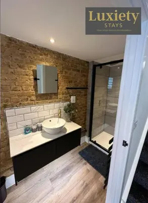 a bathroom with a sink and a shower at Sleek & Stunning 2BR APT By Luxiety Stays Short Lets & Serviced Accommodation Southend on sea With Free WiFi, Smart TV, Netflix in Southend-on-Sea