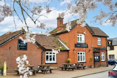 a brick building with picnic tables in front of it at Swift Host - 2 Bedrooms - Period Cottage - Garden - Village Location - Dog Friendly in Hockham