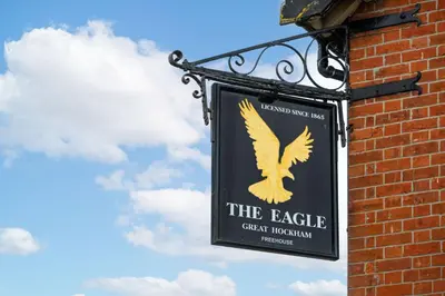 a sign on the side of a brick building at Swift Host - 2 Bedrooms - Period Cottage - Garden - Village Location - Dog Friendly in Hockham