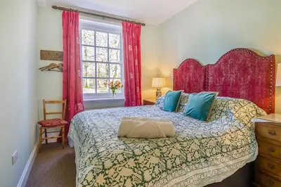 a bedroom with a large bed and a window at 3 Bed in Wymondham oc-t30596 in Wymondham