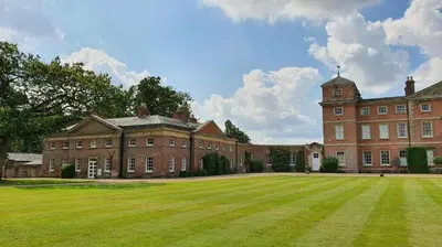 a large brick building with a large grass field at 3 Bed in Wymondham oc-t30596 in Wymondham