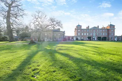 a large house with a large grassy field in front of it at 3 Bed in Wymondham oc-t30596 in Wymondham